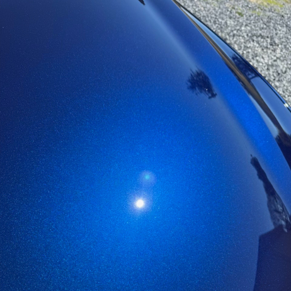 Hood of a blue car that has been washed, detailed and polished. |Mystic AC Detailing