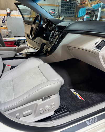 Interior of a car with white leather and dashboard with dark carpeting | Mystic AC Auto Body
