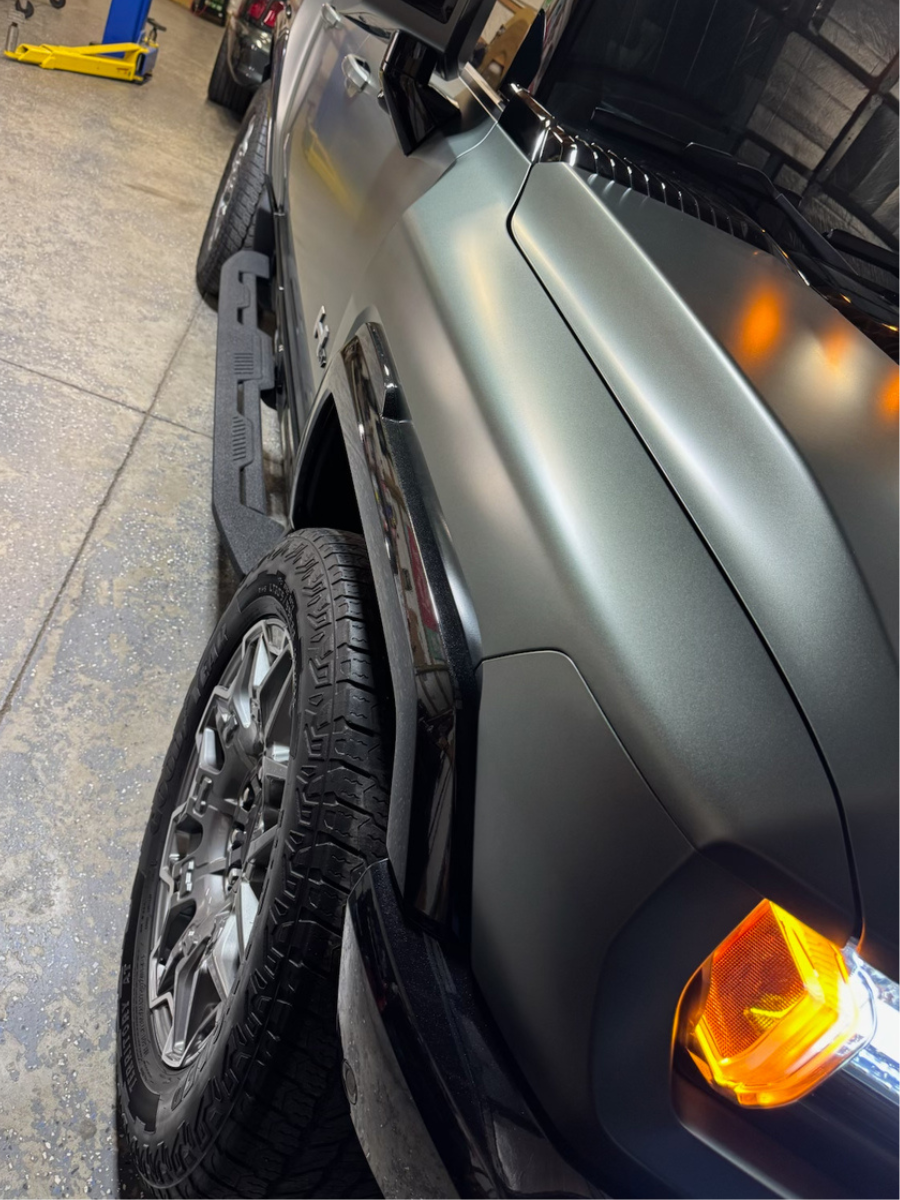 Green Hummer in a garage that has been polished and detailed | Mystic AC Detailing
