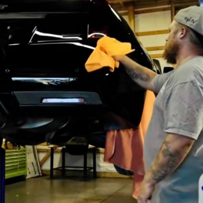 Black Cadillac receiving detailing in a garage |Mystic Auto Detailing