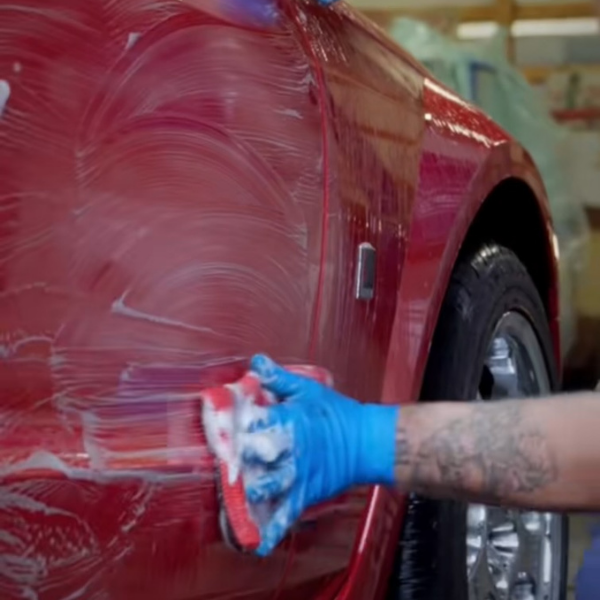 Red mustang car getting washed and detailed in a garage | Mystic Auto Detailing