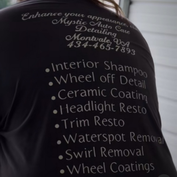 Man wearing a T-shirt with Auto Body Detailing Services listed |Mystic Auto Detailing