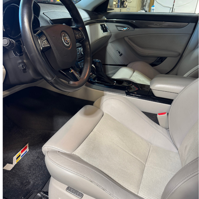 Drivers side of a white cadillac after a full service detail.
