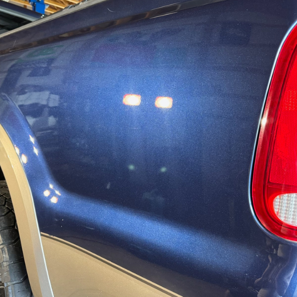 The back of a blue truck with a high shine finish after being detailed. | Mystic AC Detailing