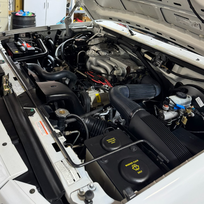 Engine cleaning services - White truck with hood open to see the cleaned engine |Mystic Auto Body Detailing